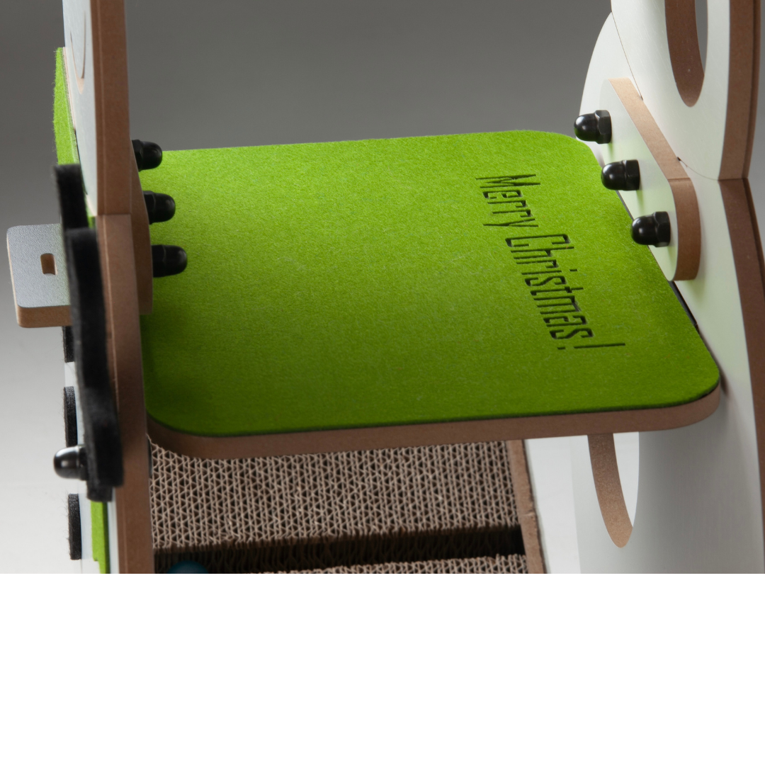 Close-up of the green felt platform insert engraved with Merry Christmas text on the luxury snowman cat furniture.