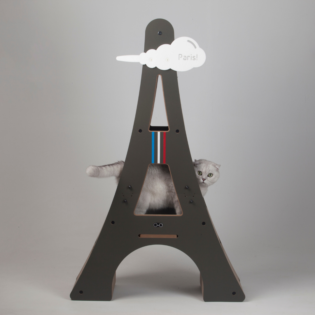 Fluffy cat lounging comfortably on the middle shelf of the multi-level Eiffel Tower cat furniture.