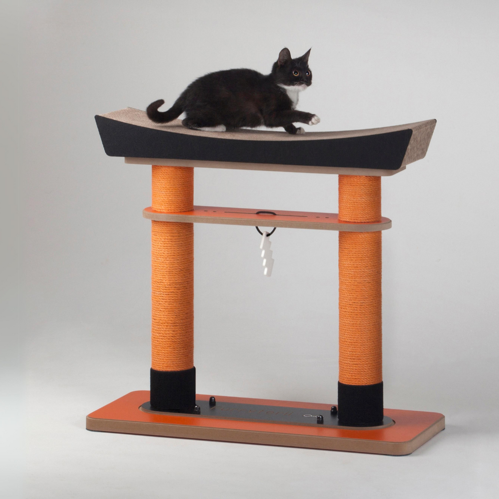 Front view of the Nekono Japan Torii Cat Tree with a black cat lounging on the top scratching surface
