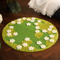 Nekono Spring Meadow 80cm circular cat scratch mat made of natural green sisal and white teddy velvet flowers, styled as a premium living room rug for cats and owners
