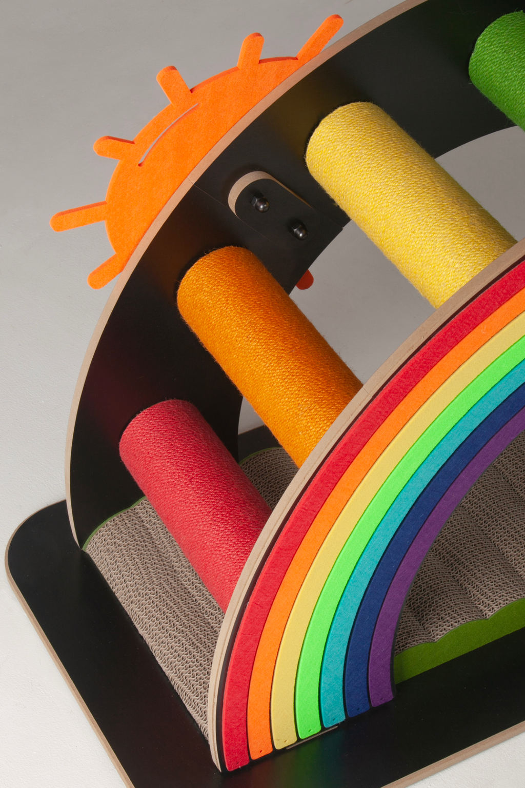 Detail of the bright orange sun and multi-colored cardboard layers of the Nekono Rainbow Bridge.