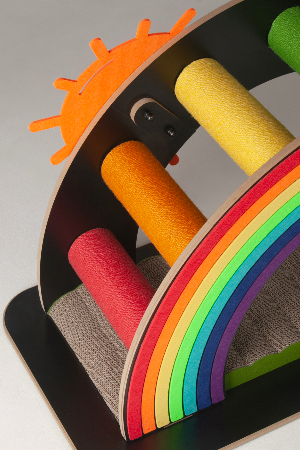 Detail of the bright orange sun and multi-colored cardboard layers of the Nekono Rainbow Bridge.