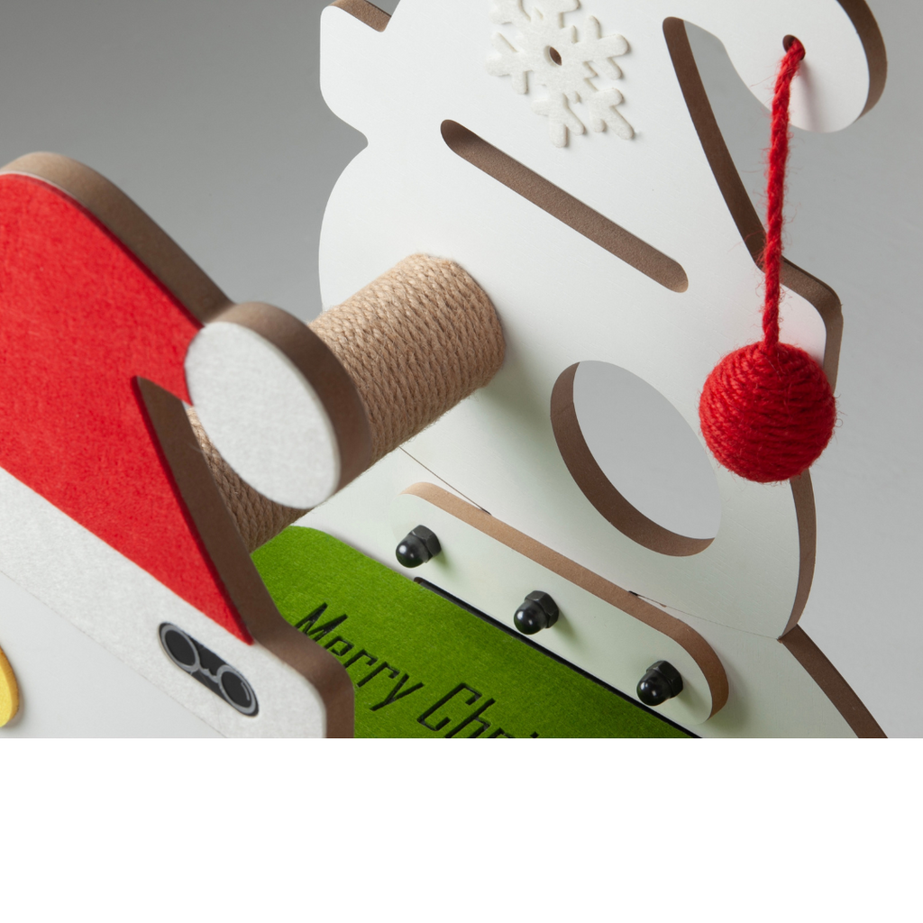 Close-up of the rear construction of the cat scratcher featuring a red hanging pom-pom toy and solid wooden post